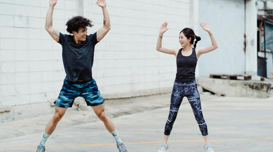 Energetic couple exercising together, illustrating how posture affects your energy levels throughout the day.
