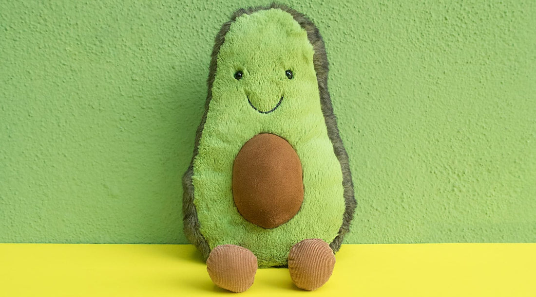 Avocado toy with large brown seed resembling a round belly, symbolizing posture’s impact on core appearance.