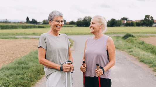 Two older women standing together, reflecting posture changes with age.
