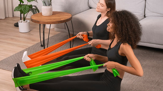 Two women using Etalon posture bands during a workout for improved posture.