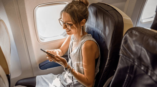Female passenger seated on plane, focused on staying comfortable and aligned.