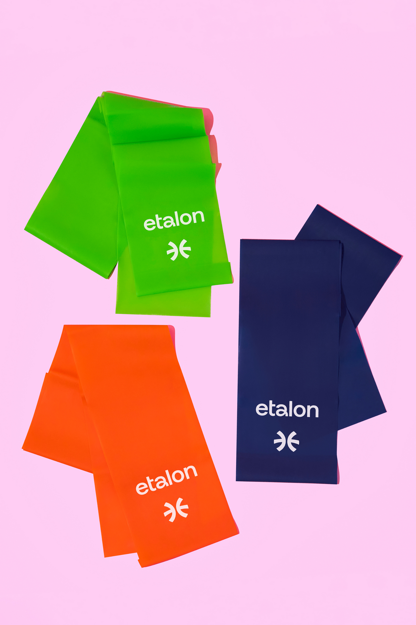 A set of green, orange, and blue Etalon latex exercise bands, ideal for posture or fitness routines.