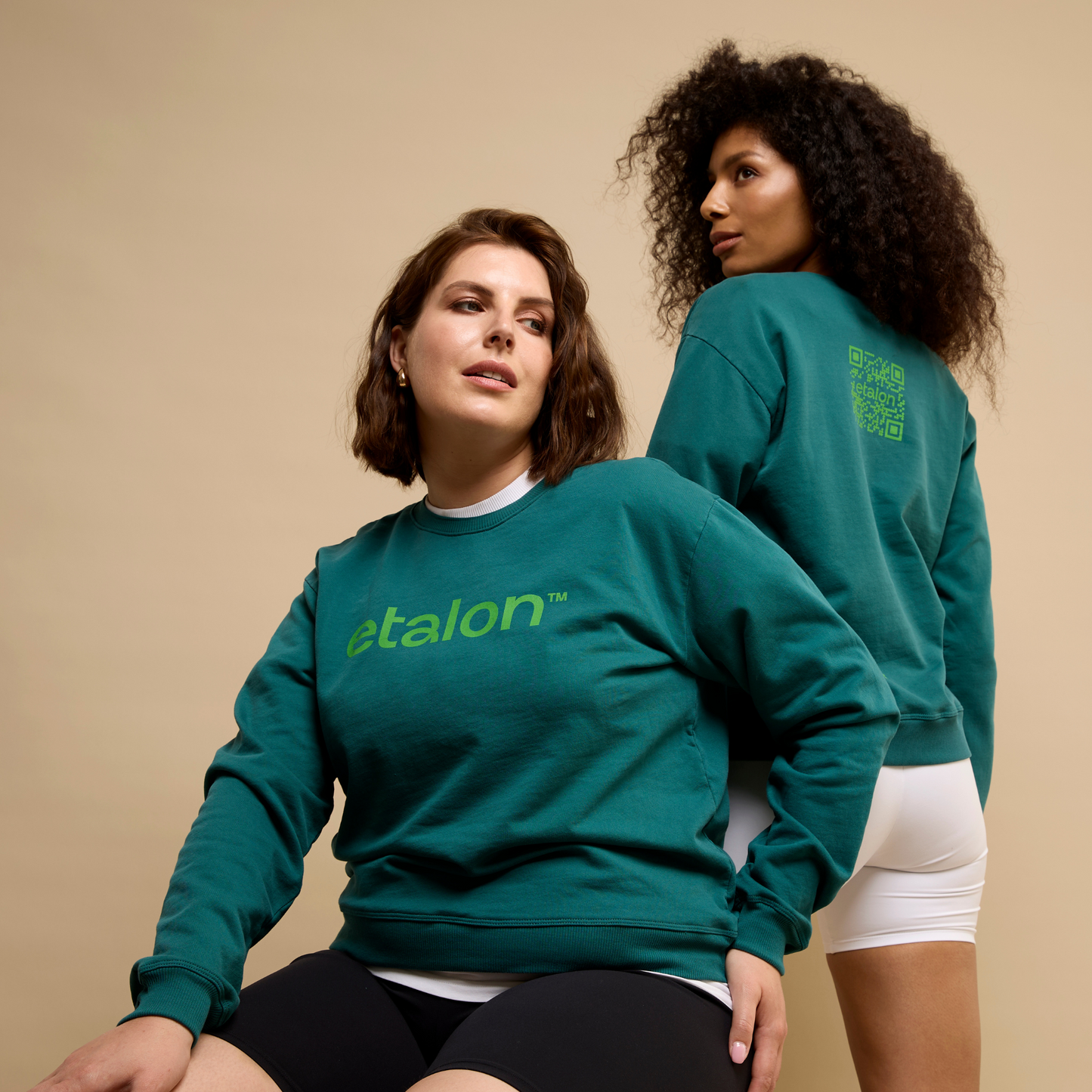 Green sustainable Etalon sweatshirt featuring a QR code printed across the upper back.