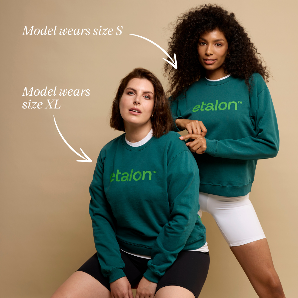 Two models wearing green Etalon unisex sweatshirts in sizes S and XL, standing in a front-facing pose.