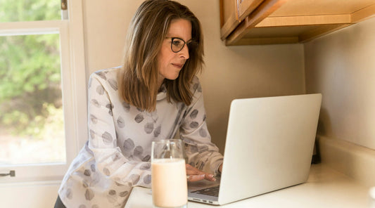 Upright woman working on laptop, showing surprising aging benefits of proper alignment.