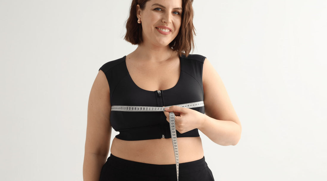 Measuring bust while wearing the black Etalon posture bra, demonstrating proper sizing for optimal back support.