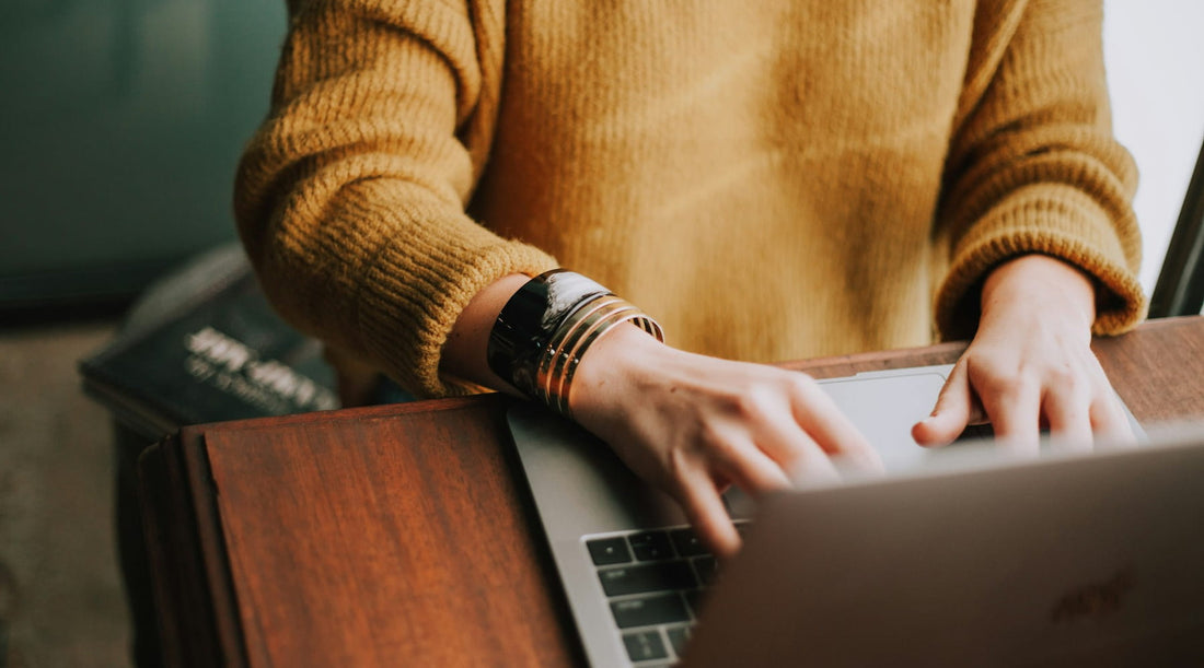Woman sitting at a desk with laptop.