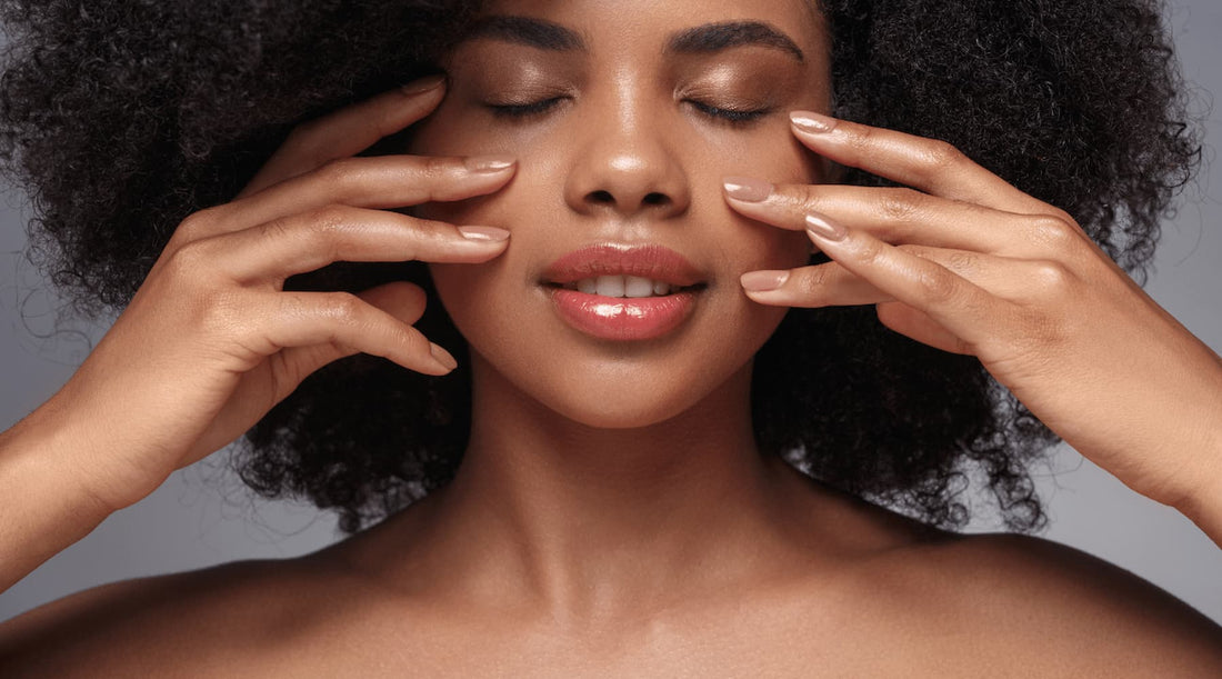 Woman with clear skin gently touching her face, reflecting posture’s effect on skin health.