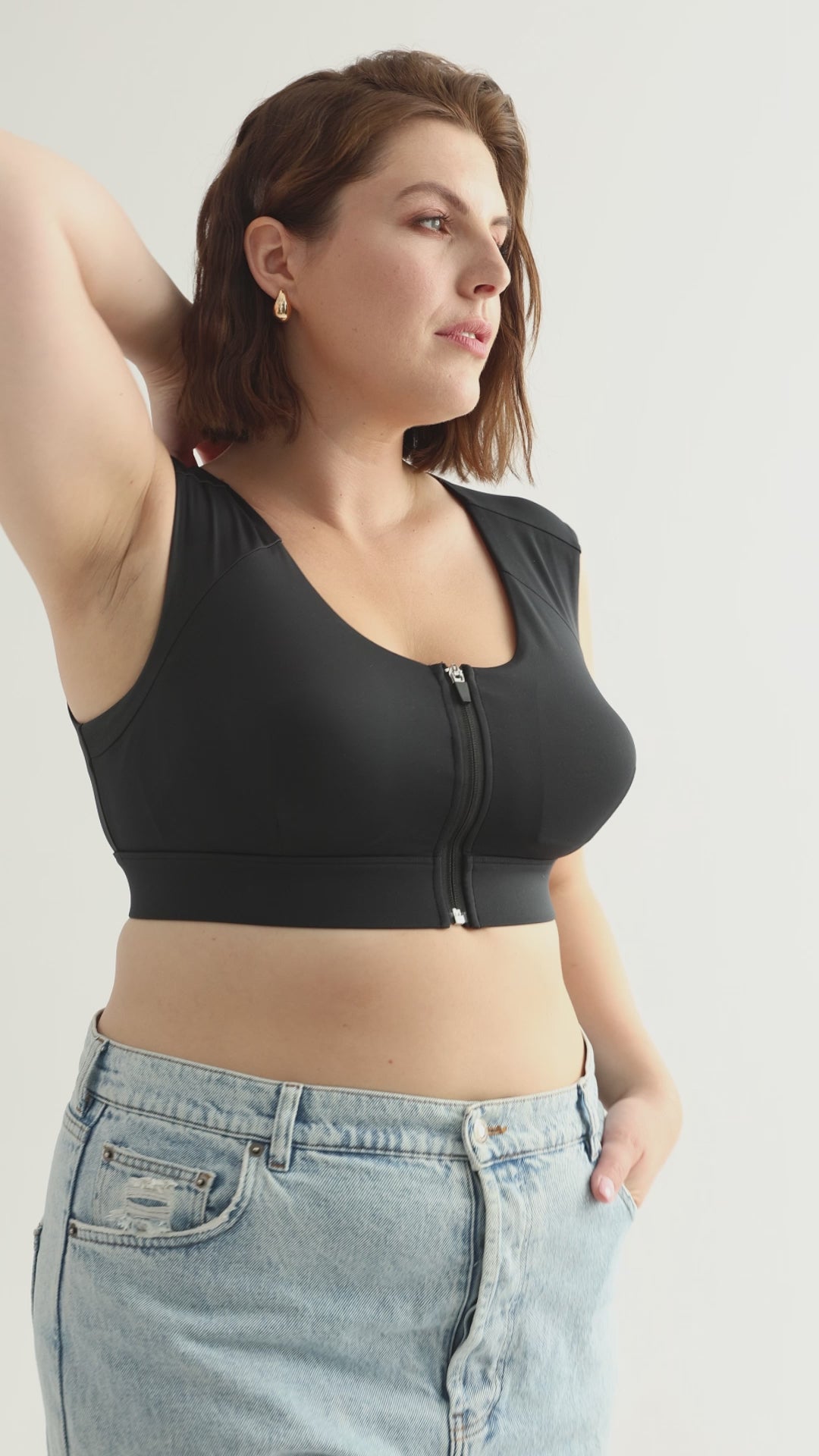 Black posture bra for improved spinal alignment.